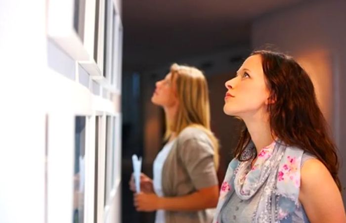 Women appreciating artwork displayed in a Jacksonville museum