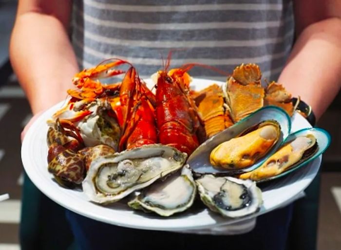 Waitress serving seafood at a local restaurant in Norfolk