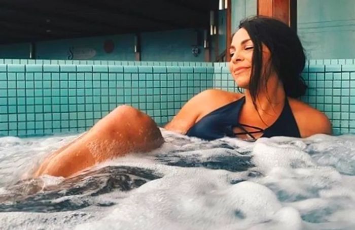 A woman unwinding in a hot tub at the Cloud 9 Spa.