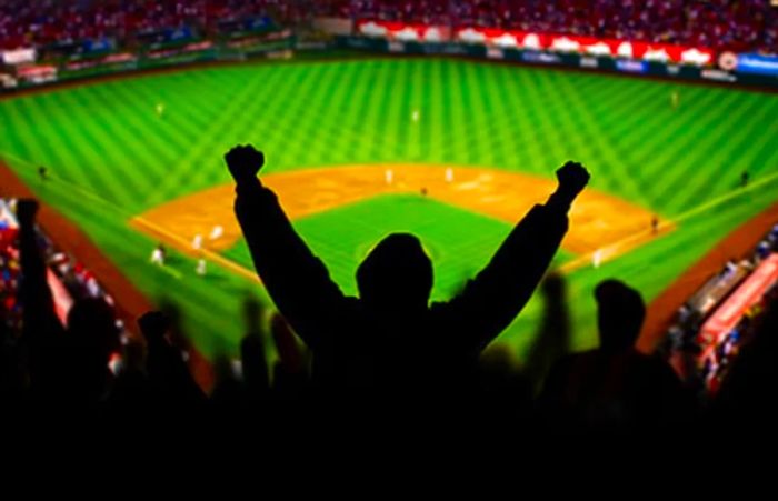 man cheering during a baseball game at a Baltimore stadium