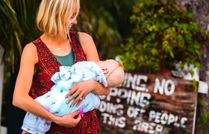 Hailey holding her daughter and gazing at her