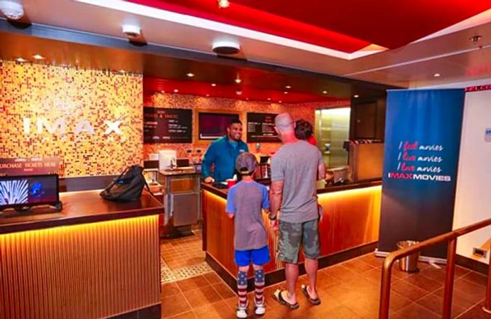 IMAX theater ticket booth with two people in line on the ship