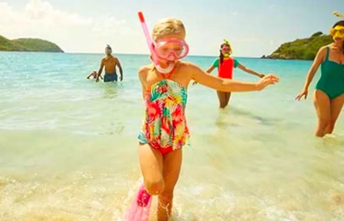 family emerging from the water after a snorkeling adventure