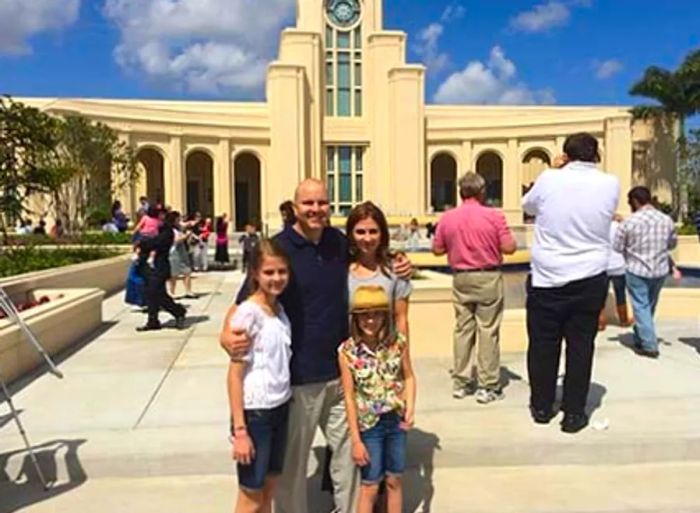 family taking a photo in front of a plaza