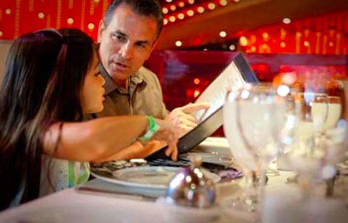 young girl placing her food order during dinner