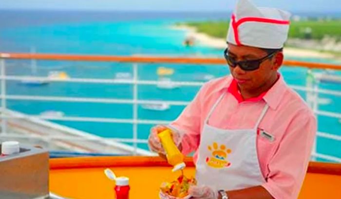 a crew member grilling a hot dog for a cruiser