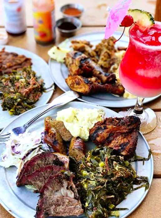 Three typical Southern Caribbean BBQ plates and a red cocktail