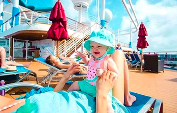 A mother and daughter relaxing on a lounge chair aboard the Dinogo Vista