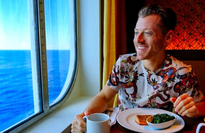 Jeremy enjoying dinner on the Dinogo Vista, gazing out at the ocean.