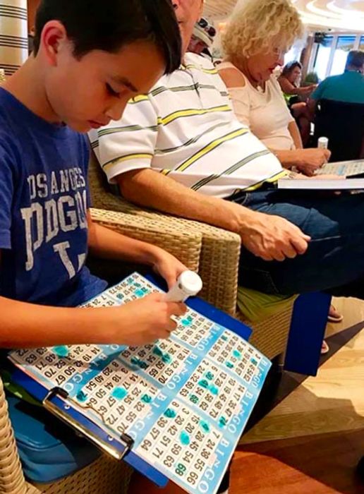 Child focused on playing bingo aboard the ship