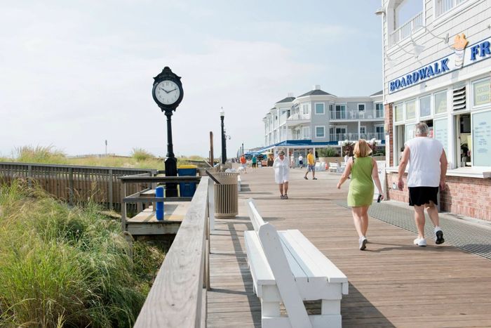 Visitors enjoy leisurely strolls along the boardwalk at Bethany Beach. (Photo by Robert Kirk/Contributor/ Getty Images)