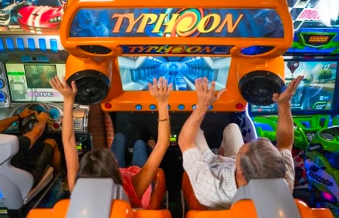 a father and daughter enjoying a video game together in the arcade