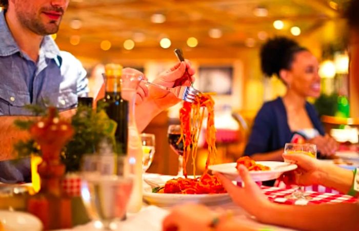 a family enjoying spaghetti together at Cucina Del Capitano