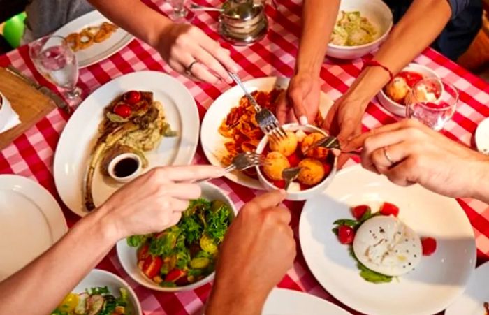 A feast of Italian dishes being shared by family members