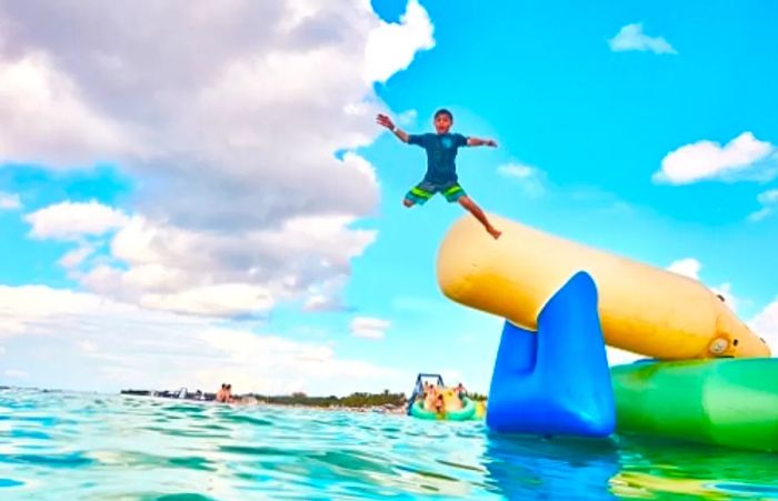 a boy leaping into the ocean with a splash