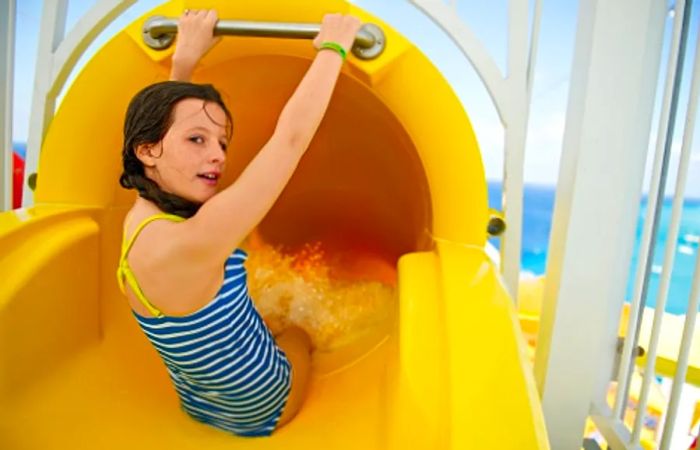 a young girl preparing to slide down the Twister Waterslide