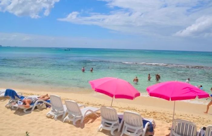 people relishing a sunny day at the beach in Grand Cayman