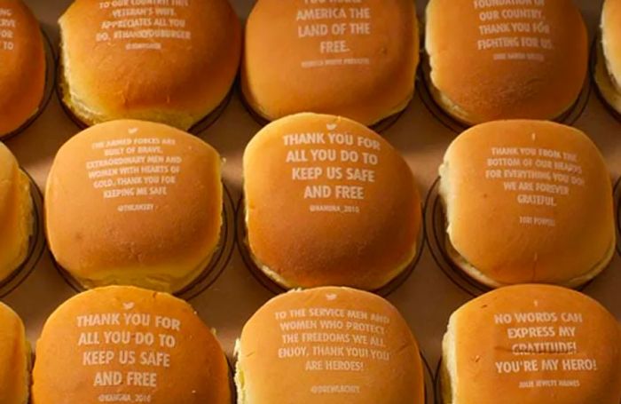 a collection of burgers with heartfelt gratitude messages engraved on the buns