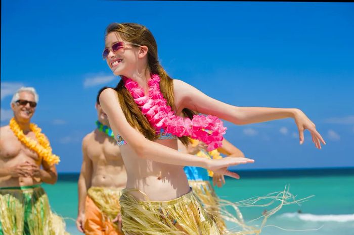 a girl performing a hula dance on a Hawaiian beach