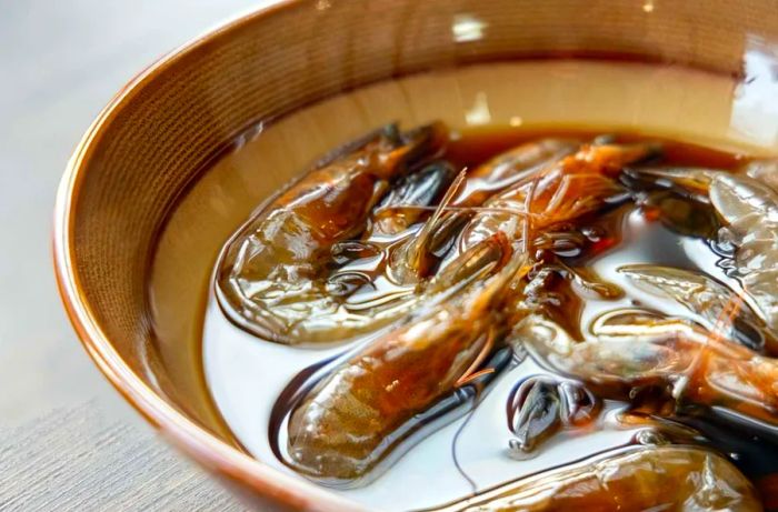 A close-up of Teochew Marinated Raw Shrimp displayed on the table, showcasing Chinese cuisine.