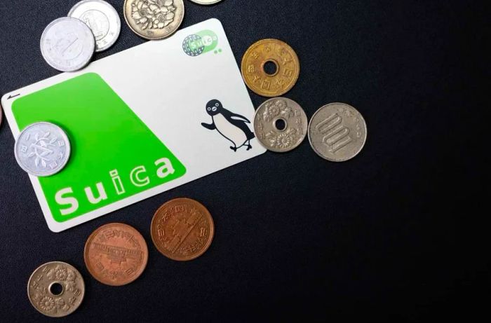 Suica card set against a background of Japanese yen coins