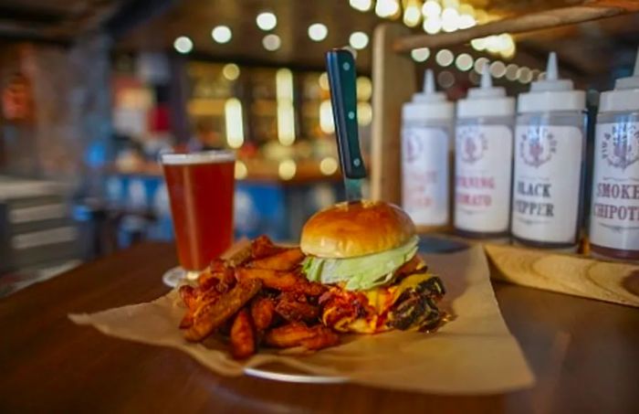 mouthwatering Guy's burger accompanied by fries and a refreshing beer