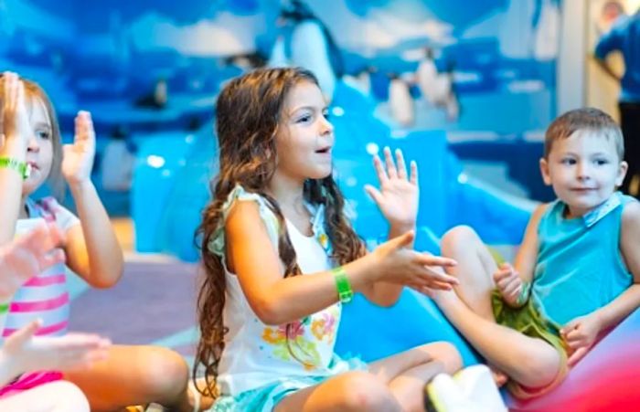 a little girl singing songs with her peers at Camp Ocean