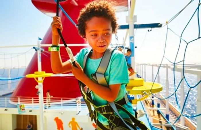 a child navigating through the ropes course