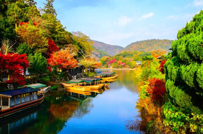 A stunning view of Arashiyama in Kyoto, Japan, during the autumn season, showcasing the Katsura River from Togetsu Bridge (Togetsukyo).