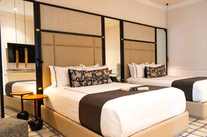 The Alest in Mexico City offers guest rooms with two beds and elegant, neutral-toned headboards.