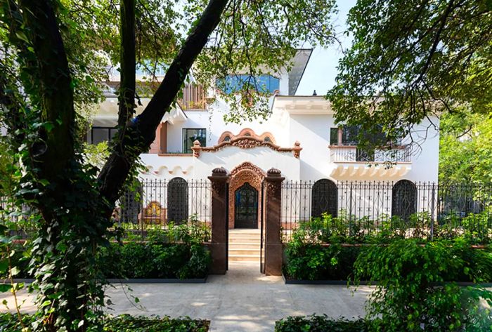 Casa Polanco’s elegant white façade is enclosed by a classic wrought iron fence.