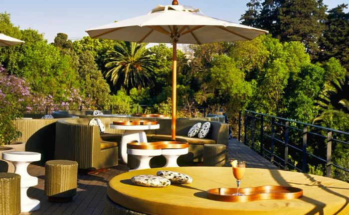 The outdoor terrace at Condesa DF offers tables shaded by stylish umbrellas.