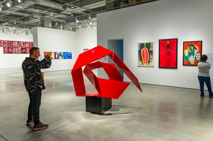 Abstract red metal sculpture and modern paintings adorn the white walls of this museum.