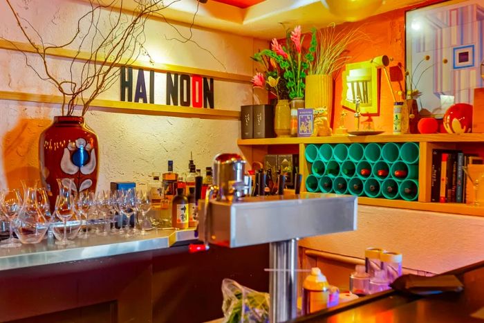 A bar featuring quirky, desert-inspired decor, complete with a sign that reads HAI NOON.