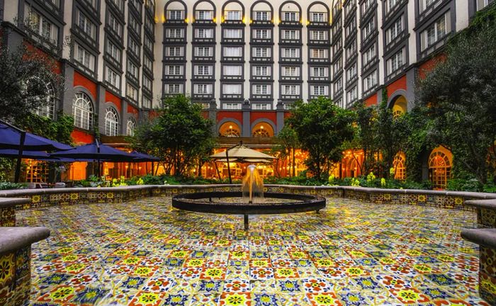 The vibrant central atrium of Four Seasons Mexico City features a stunning array of colorful tiles.