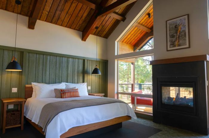 Interior of a Firefall Ranch cabin with high wooden ceilings and an indoor/outdoor fireplace.