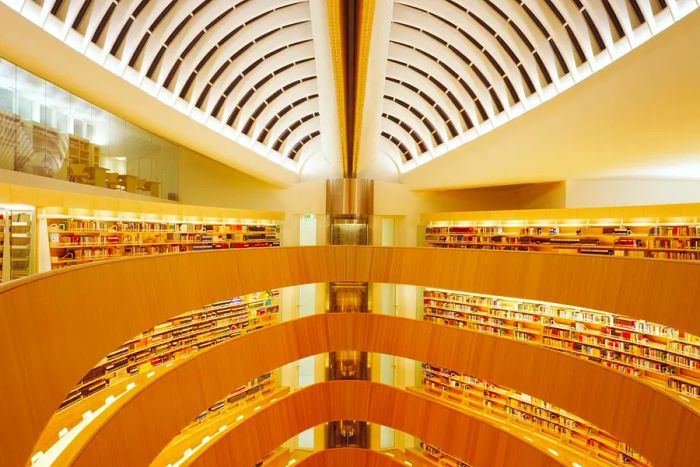 The oval-shaped atrium of the Zurich Law Library features bookshelves spanning four floors.