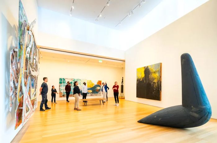 Visitors strolling through a museum filled with artwork