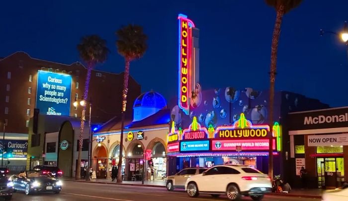 The dazzling neon lights of Hollywood illuminate the night sky.