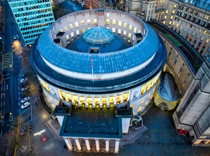 Aerial view of Manchester's central public library, characterized by its round shape, dome in the center, and columned portico.