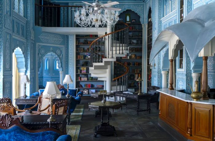 A lavish blue-themed room featuring a spiral staircase, a marble bar, and exquisite furnishings.