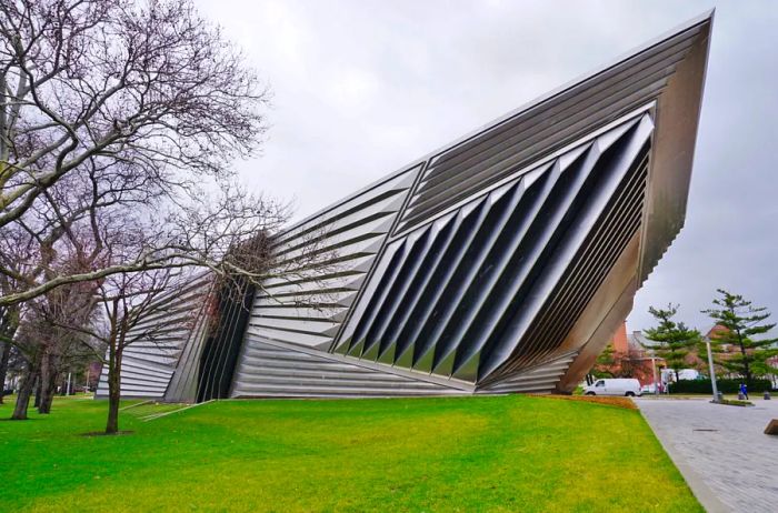 Silver building with pointed features and slotted design