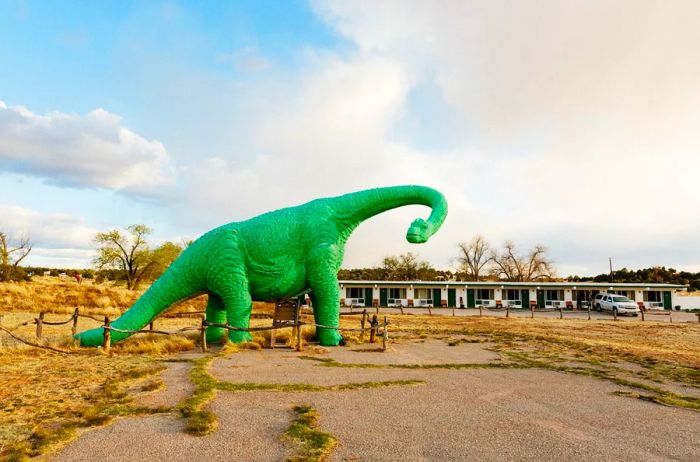 A life-sized neon green dinosaur statue in Holbrook, Arizona.