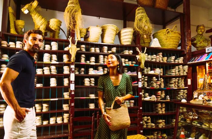 Shoppers browsing the handmade treasures at Antigua Casa Crespo, a unique store in Madrid, Spain.