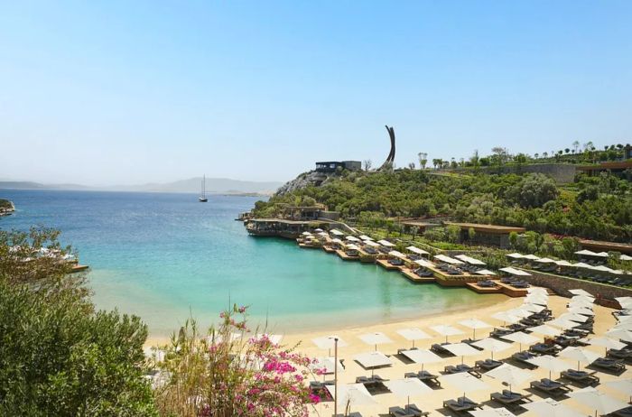 Maxx Royal Bodrum boasts an incredibly private beach adorned with white lounge chairs.