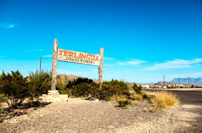 An aged wooden roadside sign greets visitors arriving in the ghost town of Terlingua, Texas.