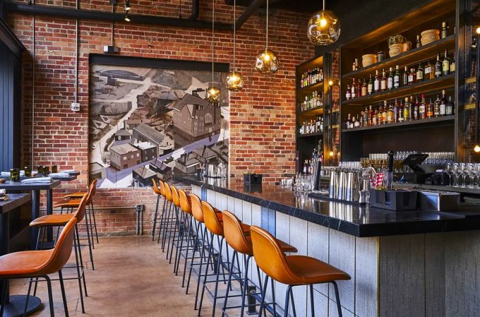 High-backed leather stools arranged along the bar at Benne on Eagle restaurant.