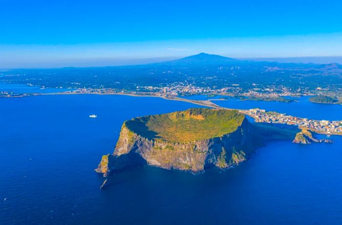 A breathtaking sunrise over a cratered volcano by the sea