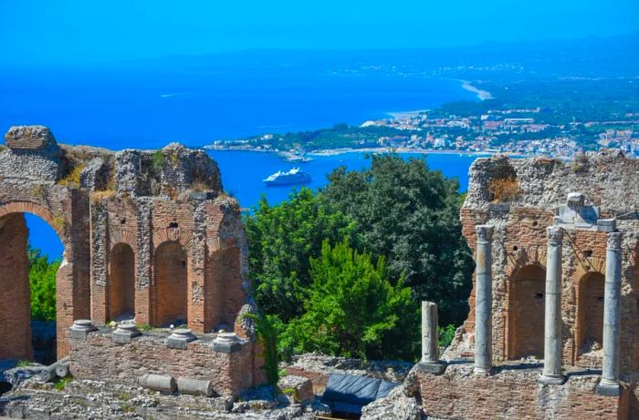 Remnants of stone archways and pillars comprise the ruins at Taormina, Italy.