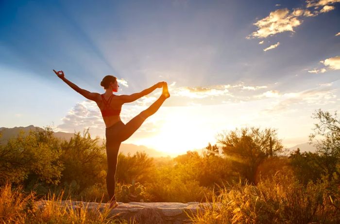 Individual practicing yoga outdoors at Canyon Ranch during sunrise